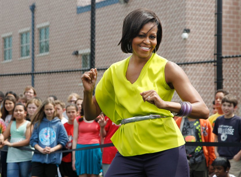 First lady Michelle Obama dances with students at Alice Deal Middle School in northwest Washington, Tuesday, May 3, 2011, during a surprise visit for the school's Let's Move! event.    (AP Photo/Manuel Balce Ceneta)